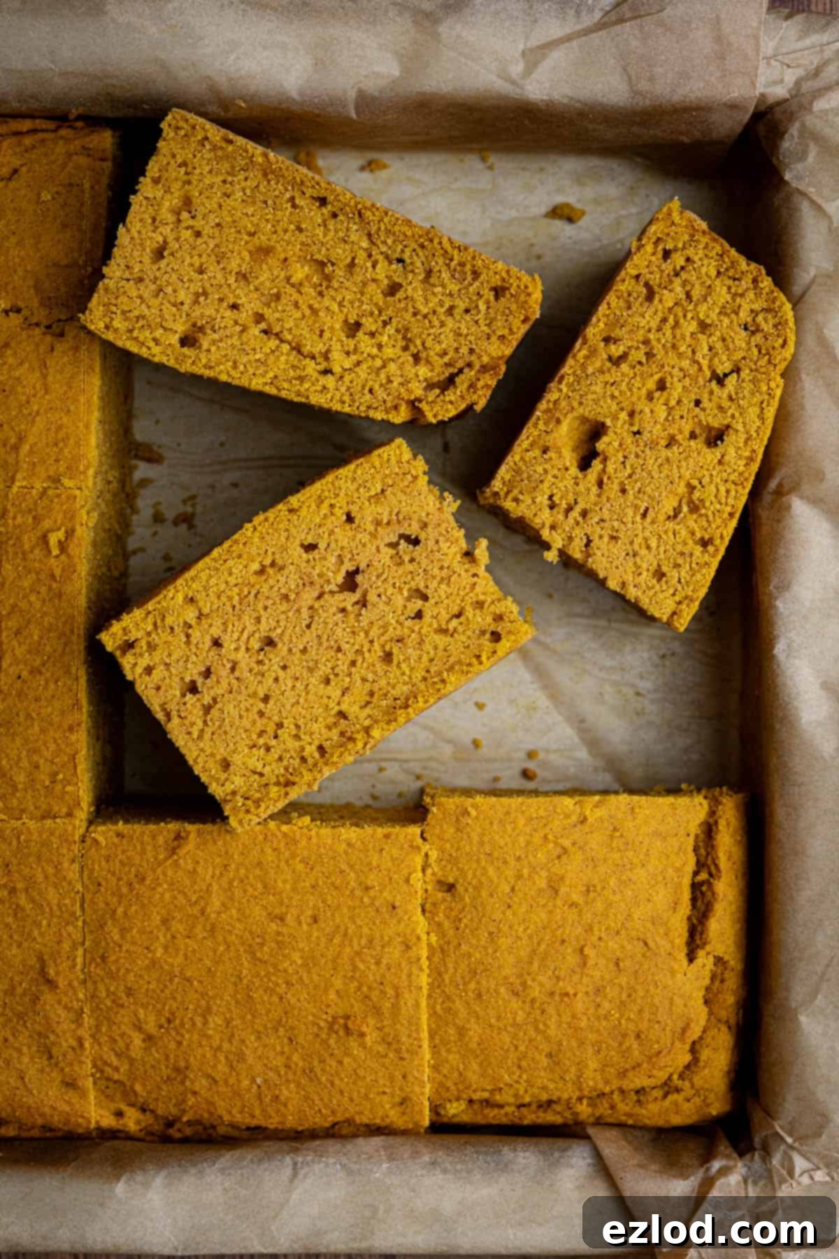 Golden Harvest Vegan Cornbread 10 Squares of vegan pumpkin cornbread in a baking paper lined tin.