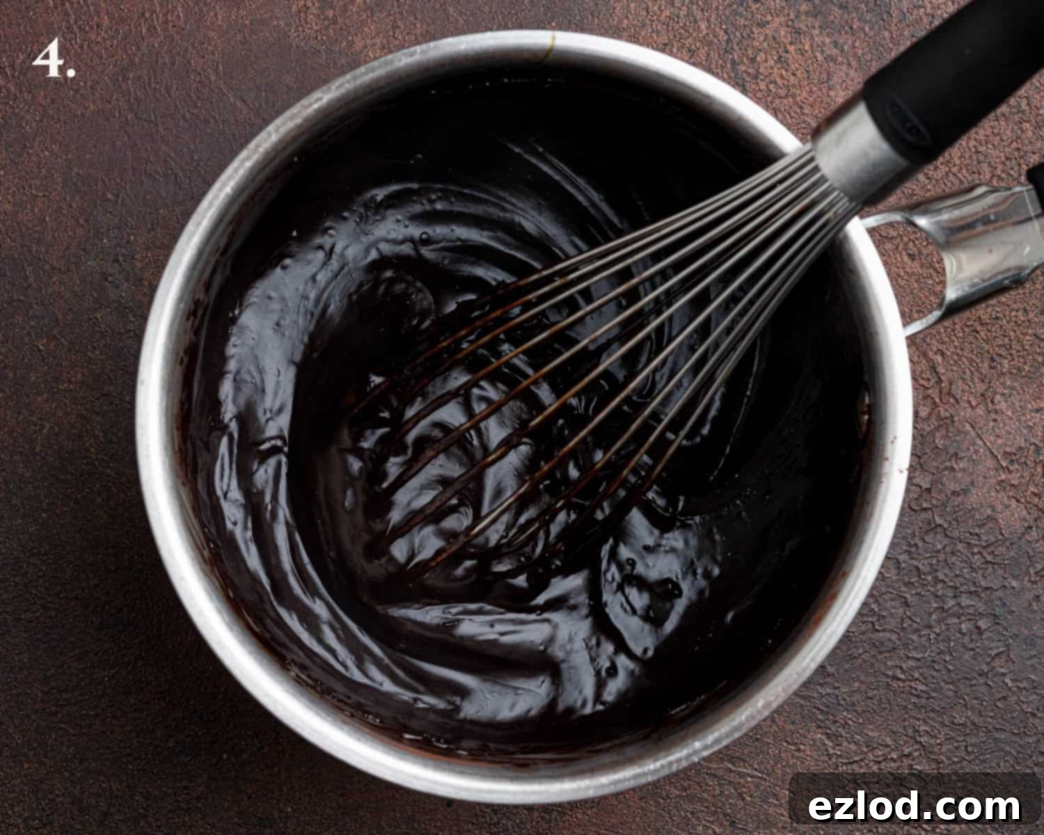 Decadent Vegan Treacle Chocolate Cake 9 Step 4 in making treacle chocolate cake frosting: the thickened, glossy fudge frosting base in a saucepan.