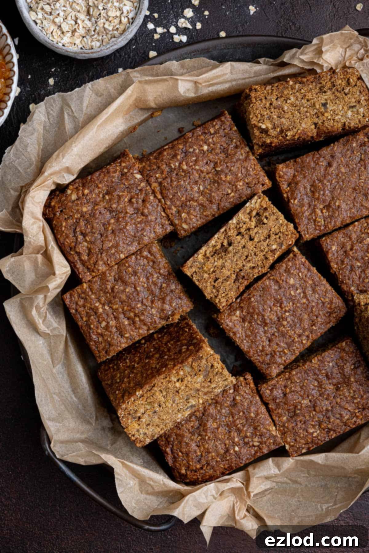 Squares of vegan Thor cake on a baking parchment lined tray.