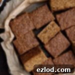 Squares of vegan Thor cake on a baking parchment lined tray.