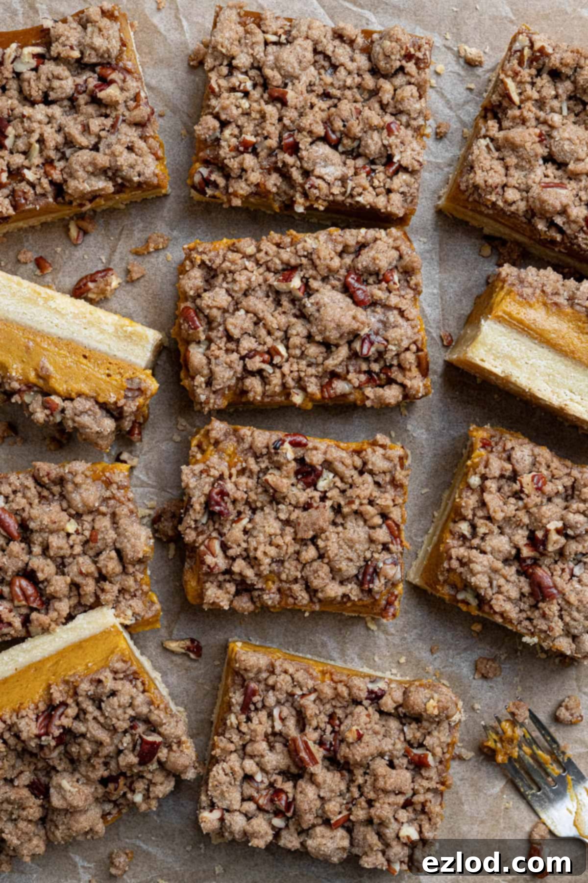Beautifully arranged vegan pumpkin crumb bars on a sheet of baking paper, ready to be enjoyed.