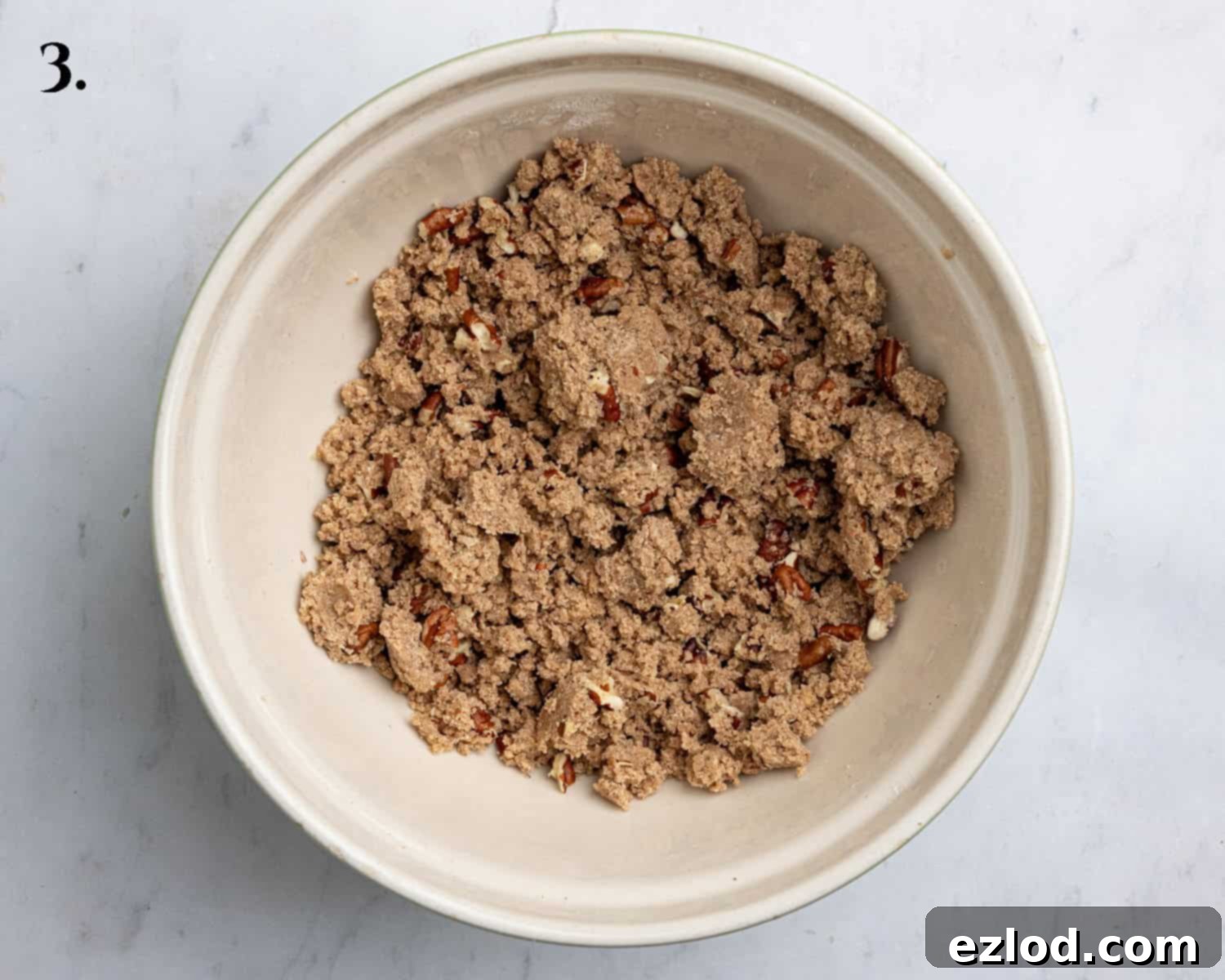 Step 3: A clear image depicting the prepared streusel topping, a mix of flour, sugar, cinnamon, and pecans, ready to be sprinkled.