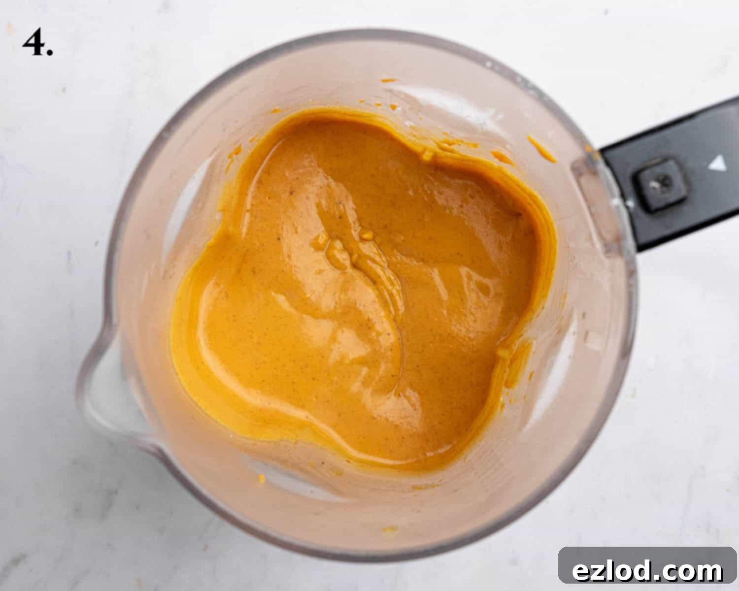 Step 4: A vibrant image showing the perfectly blended, smooth, and creamy pumpkin filling in a blender, ready for assembly.