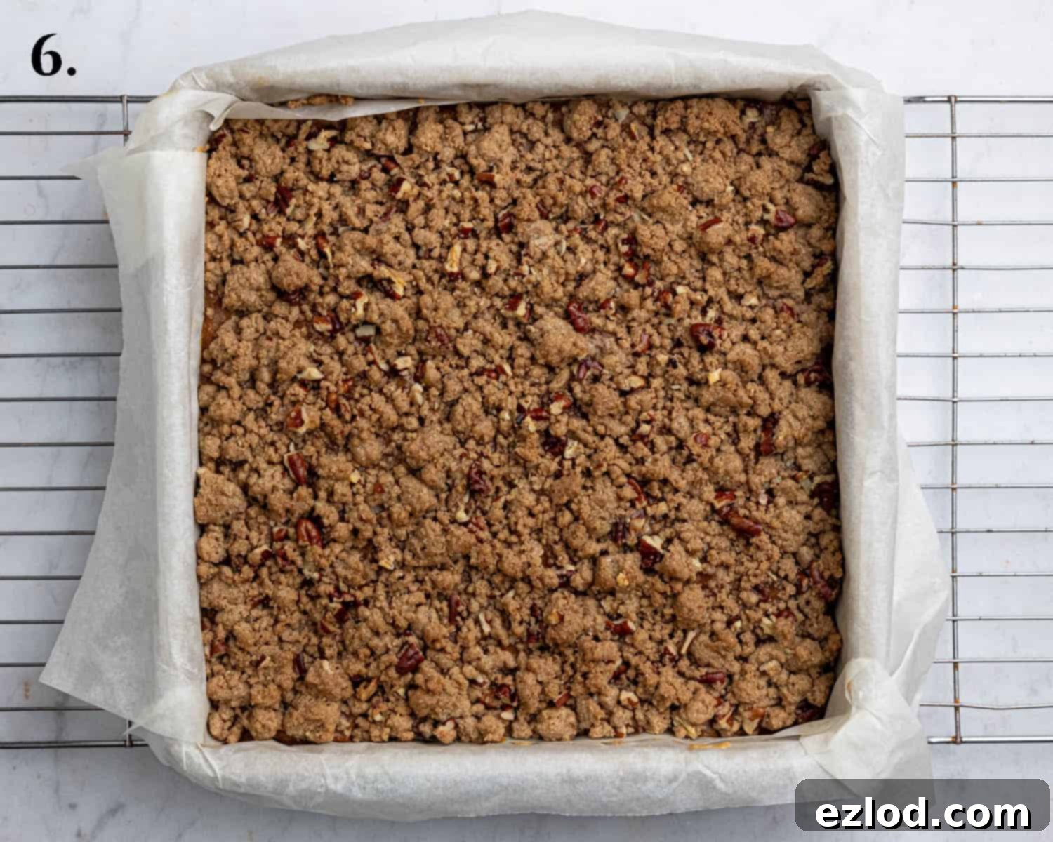 Step 6: An enticing image of the freshly baked vegan pumpkin crumb bars, golden and ready to cool, showcasing the set filling and crisp streusel.