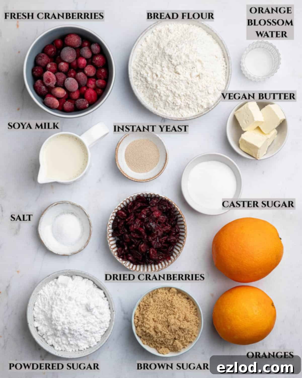 A labelled photo of the ingredients needed to make vegan cranberry orange rolls.