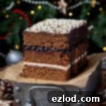 Vegan Piernik on top of a metal tray in front of a Christmas tree.