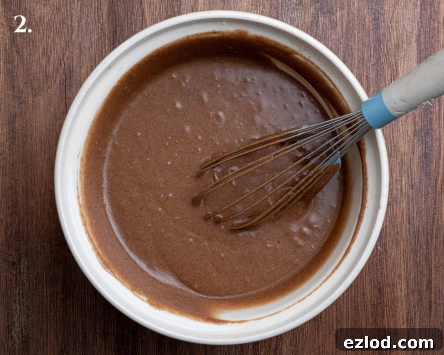 The perfectly mixed batter for Vegan Piernik, showcasing its smooth texture and rich color, ready for baking.