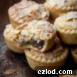 Close up of a vegan frangipane mince pie with a bite taken out of it.