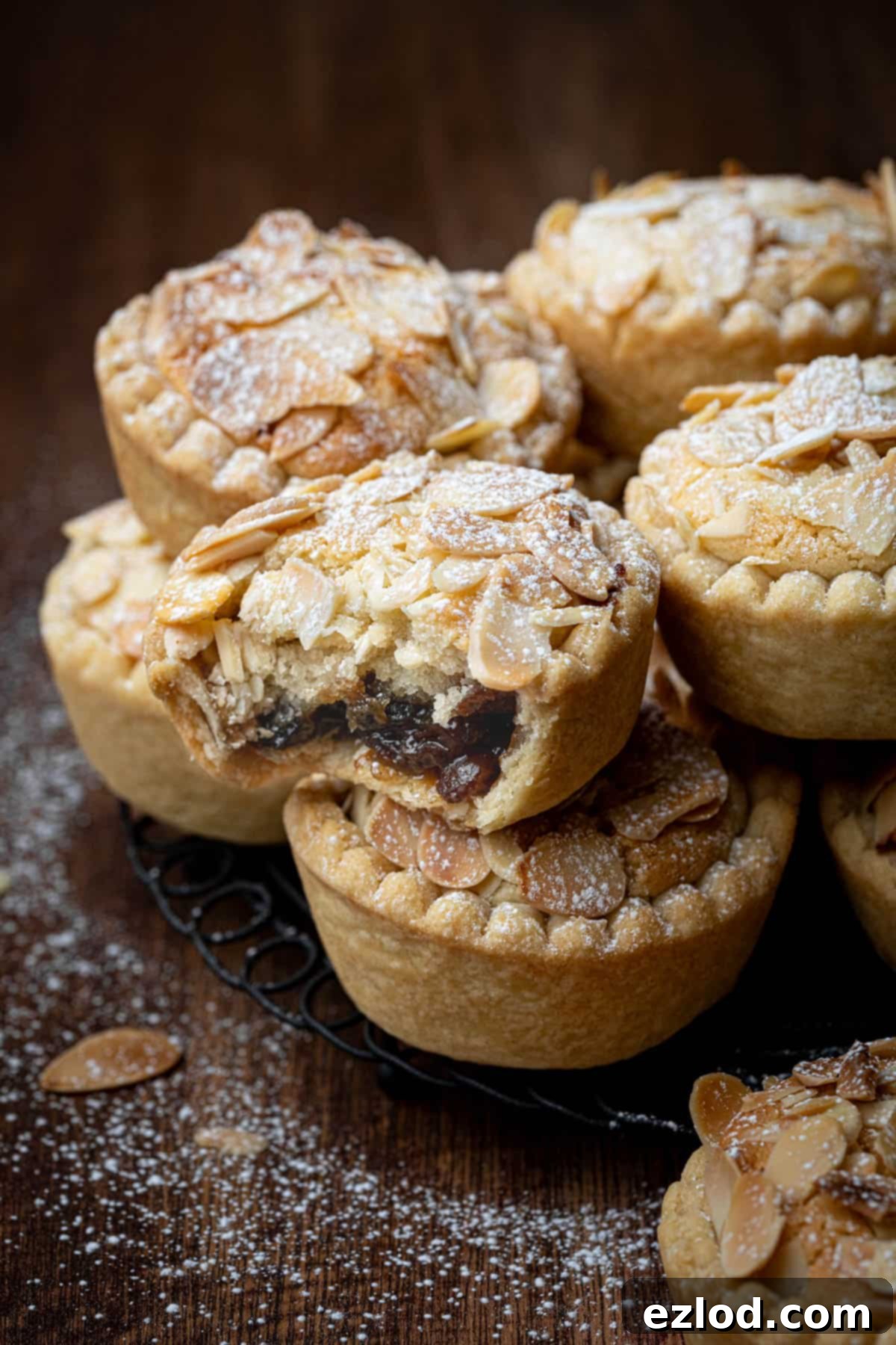 Close up of a vegan frangipane mince pie with a bite taken out of it.