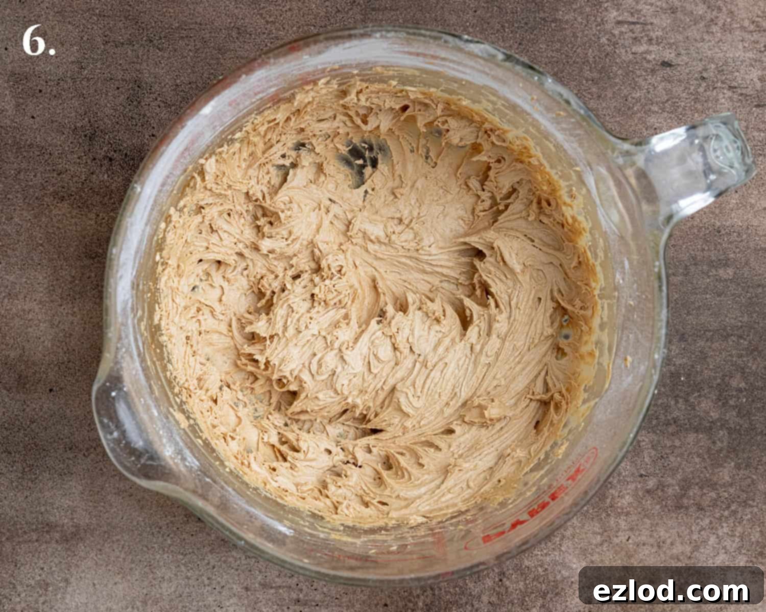Step 6: The perfectly whipped coffee buttercream sits in a mixing bowl, showcasing its light and fluffy consistency.