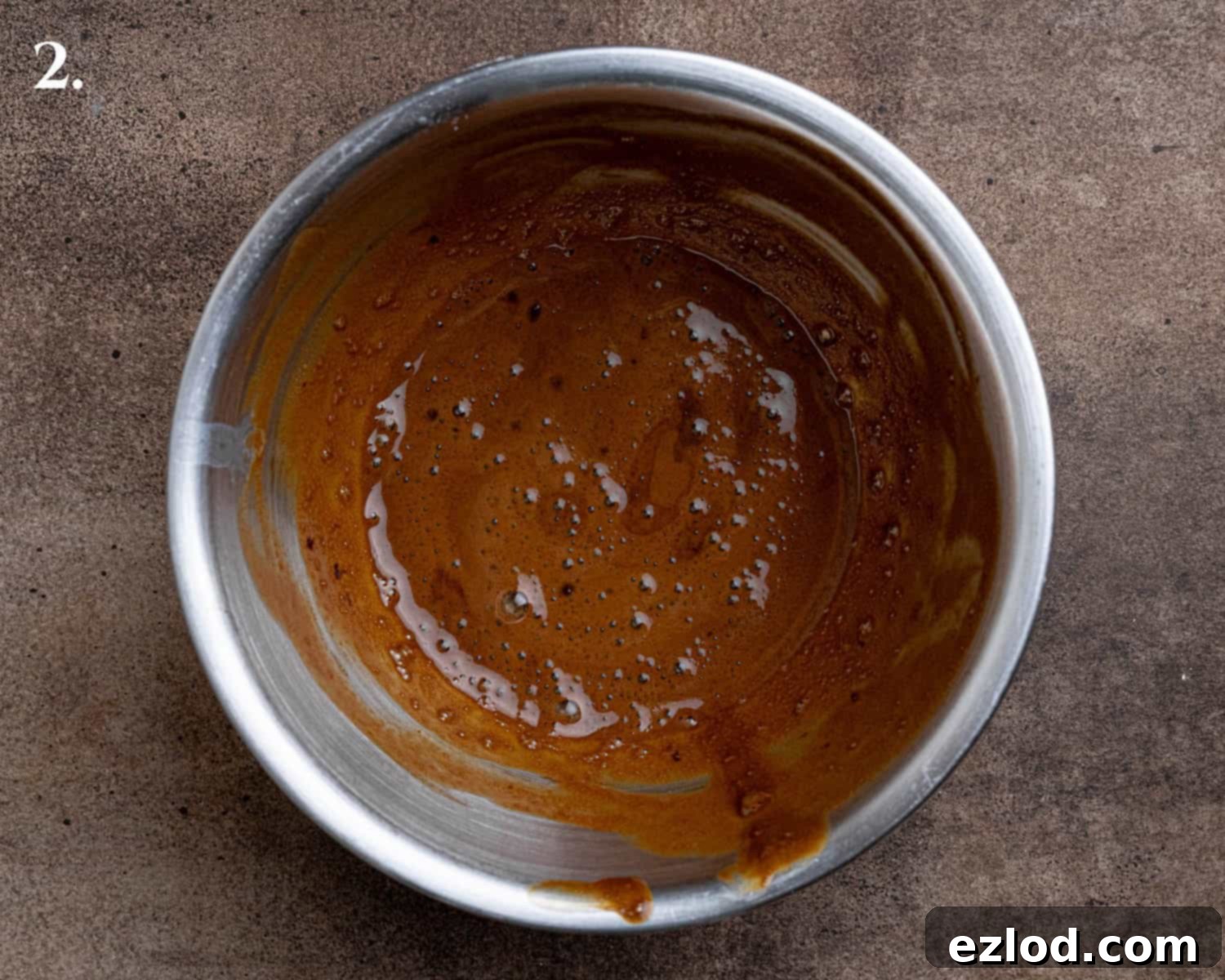 Step 2 of the recipe: A small bowl contains the perfectly dissolved coffee mixture, ready to be incorporated into the biscuit dough.