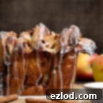 Close up of the side of the loaf of apple cinnamon pull-apart bread, highlighting its beautiful layers and golden crust.