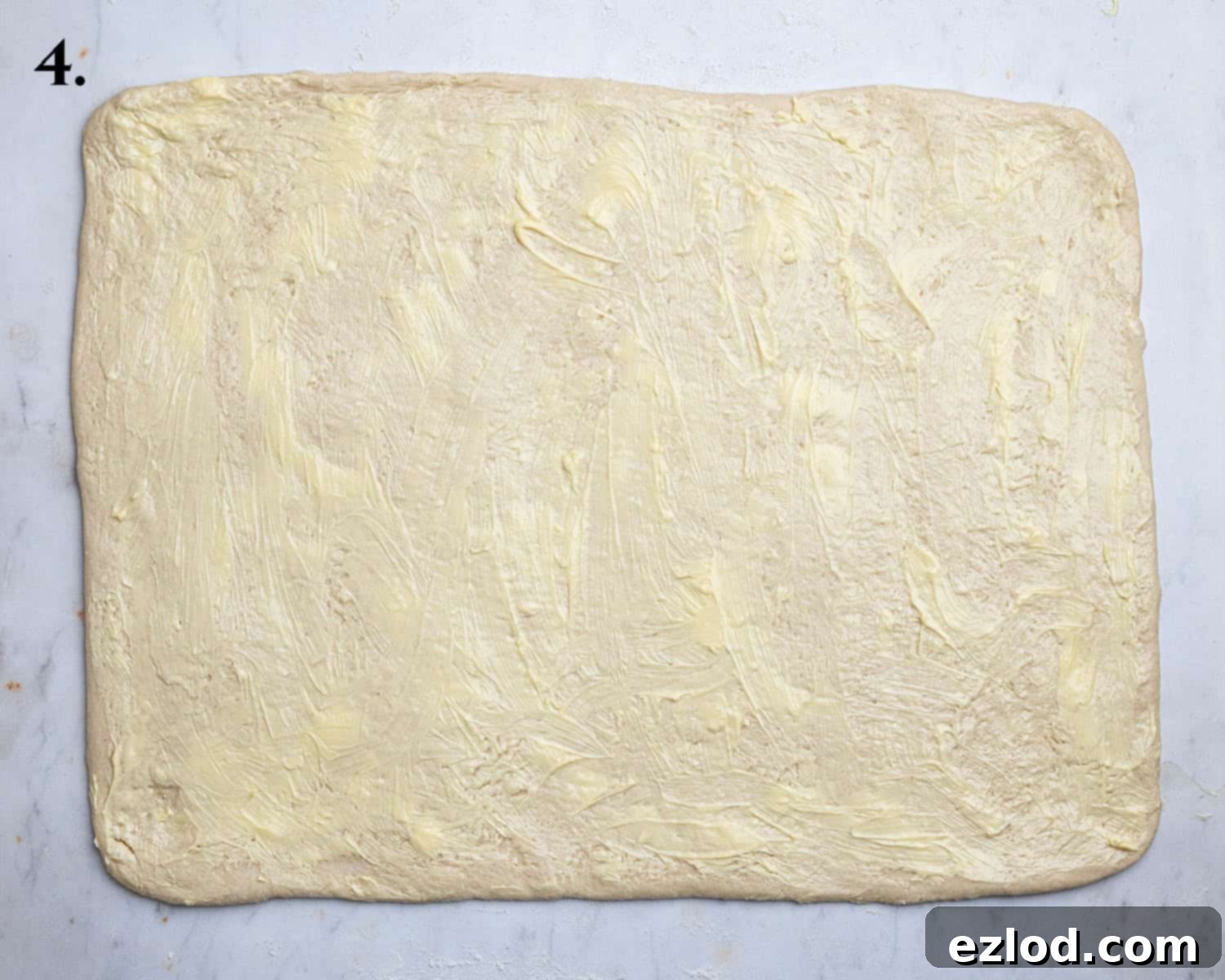 Step 4: The rolled out dough rectangle, evenly spread with softened vegan butter, ready for the apple filling.