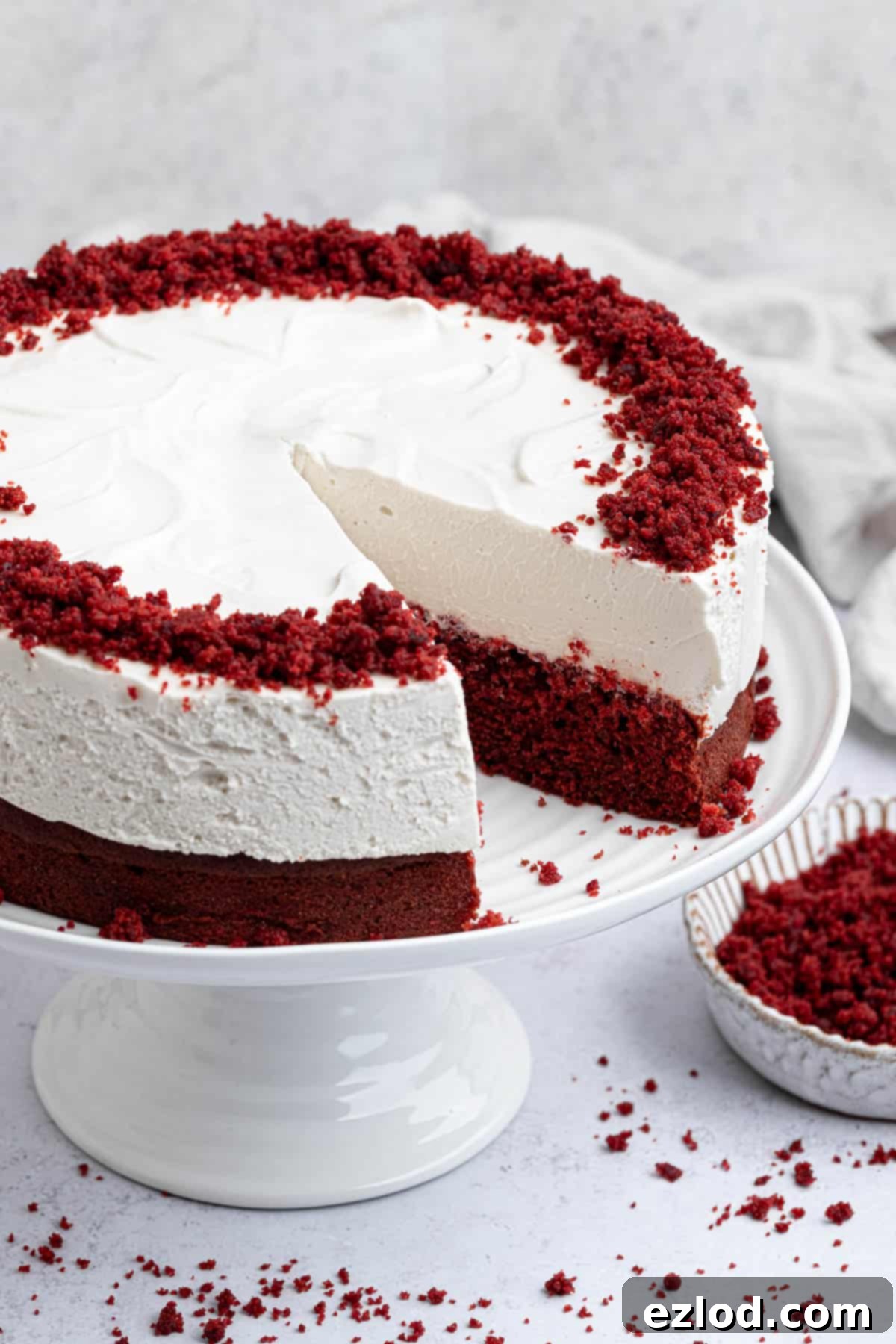 Close up of vegan red velvet cheesecake cake with a slice removed.
