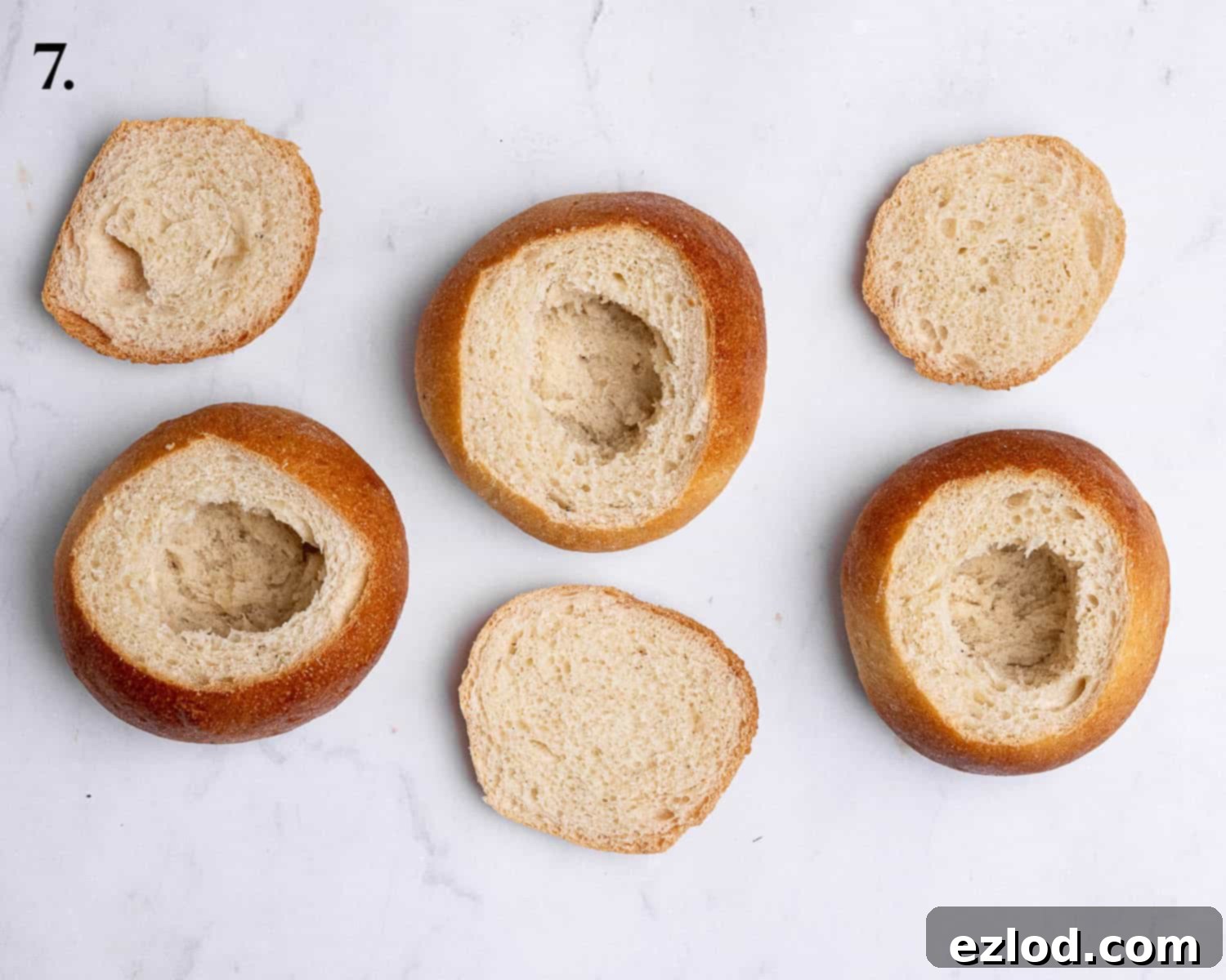 Homemade Vegan Semlor 11 Step 7, the buns with the tops removed and centres hollowed out.