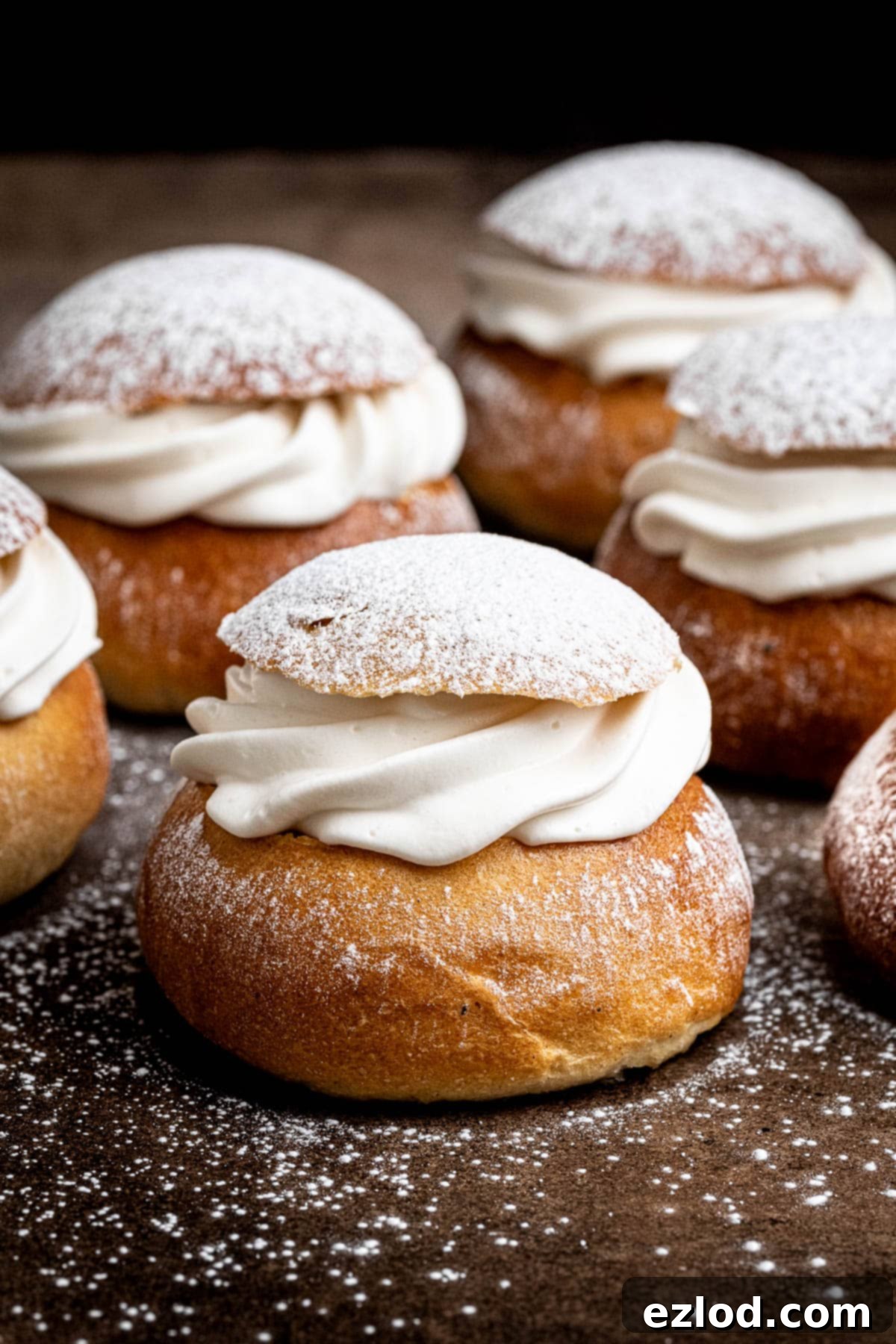 Homemade Vegan Semlor 15 Vegan semlor dusted with icing sugar.