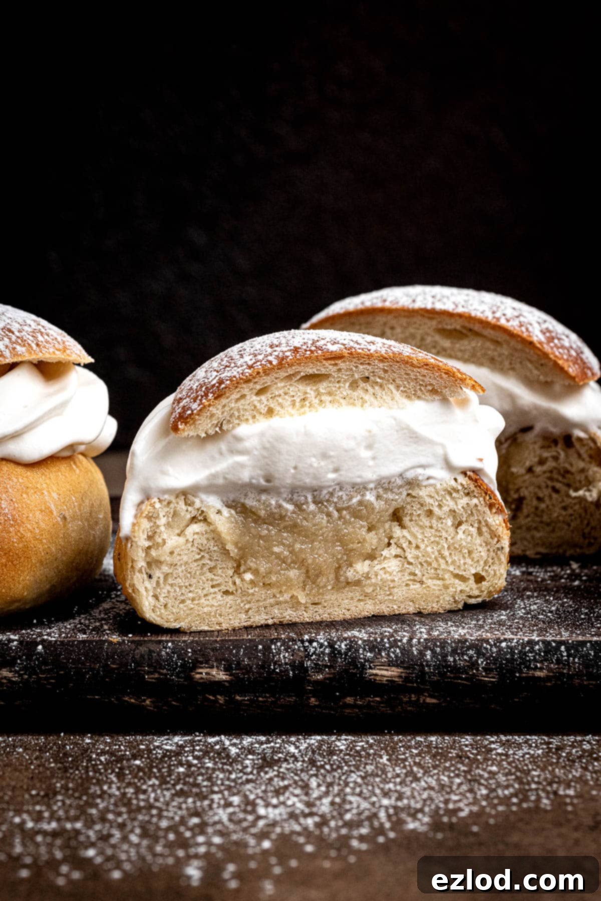 Homemade Vegan Semlor 4 Close up of a Semla bun sliced in half.