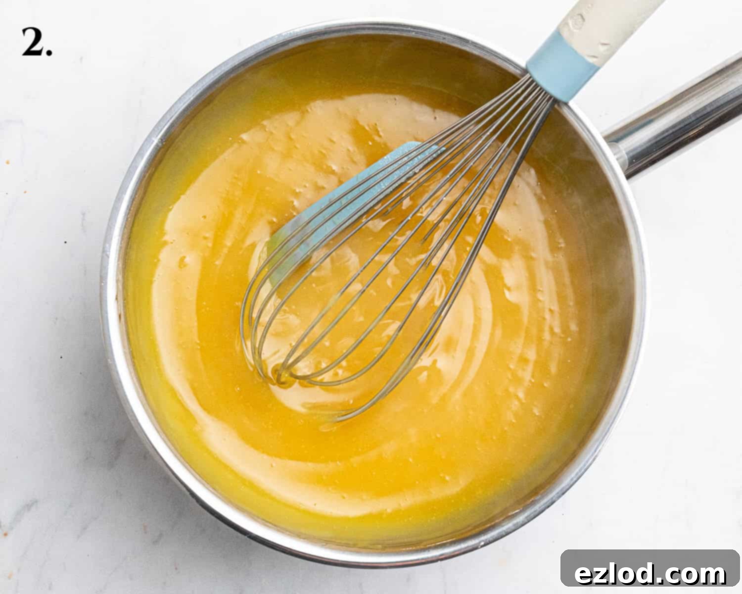 Step 2, the passion fruit curd after being cooked to a thick consistency in the saucepan.