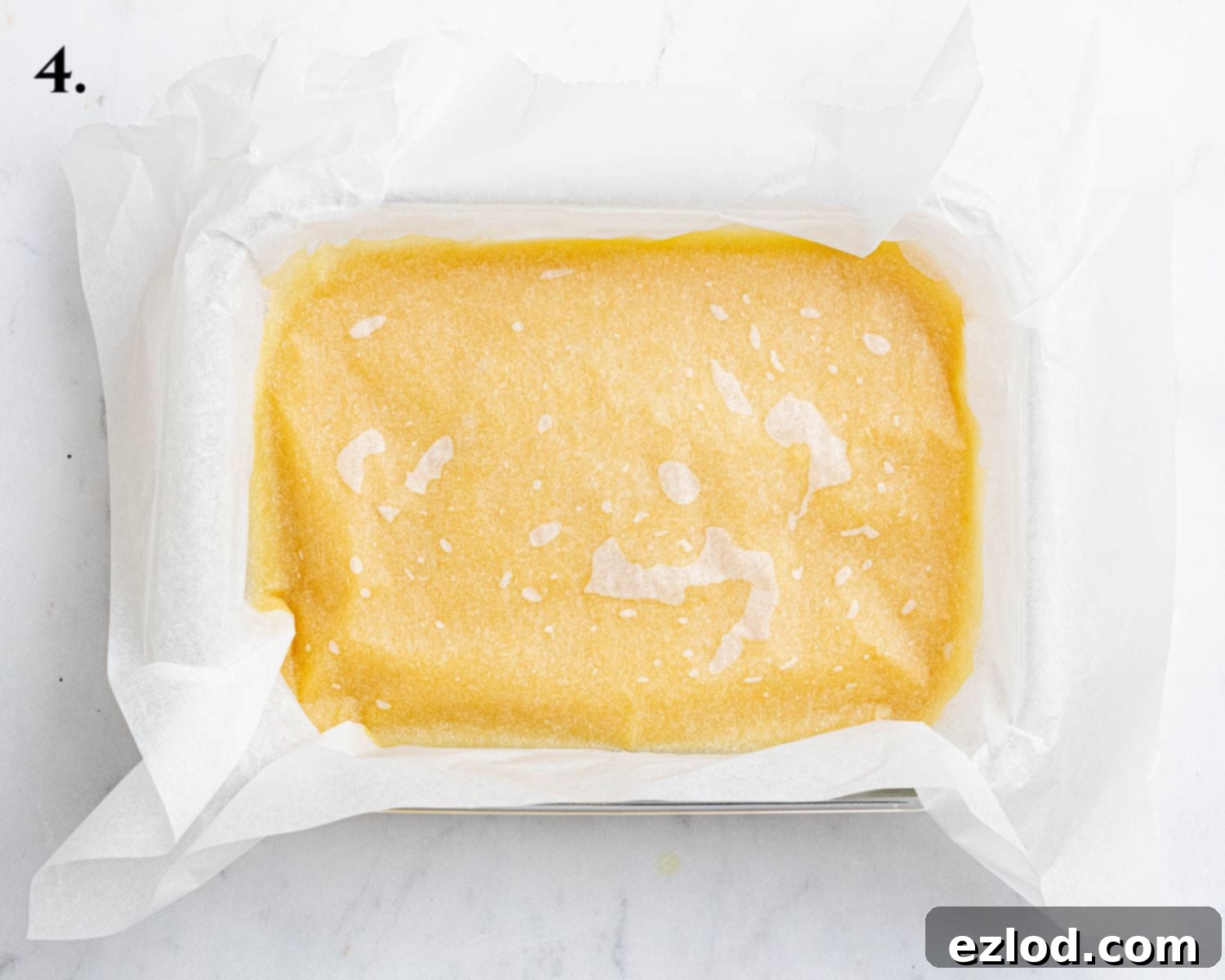 Step 4, the vegan passion fruit curd resting in a container, covered with baking paper to prevent a skin from forming.