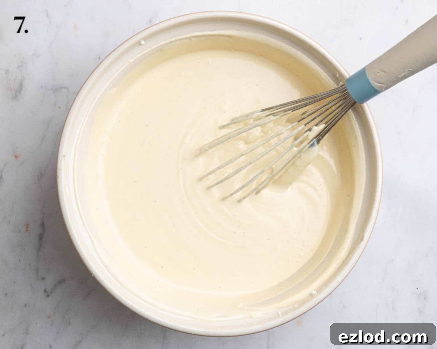 Step 7: The complete cheesecake filling, a creamy and airy mixture, gently folded and ready to be poured.