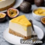 A slice of vegan passion fruit cheesecake on a plate with a forkful removed.