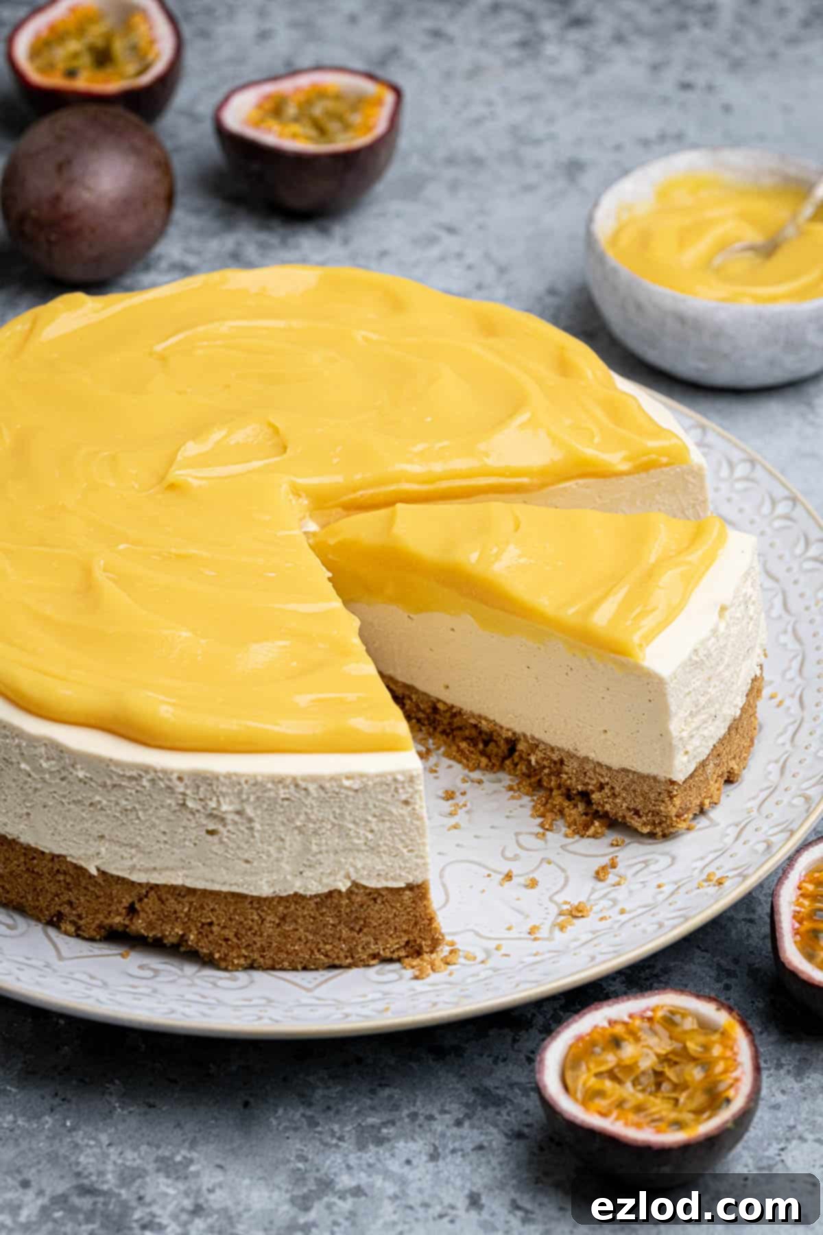A perfectly sliced vegan passion fruit cheesecake on a pristine white plate, showcasing its layers.