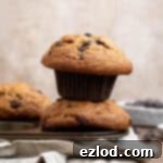 A stack of two vegan banana muffins on a muffin pan.
