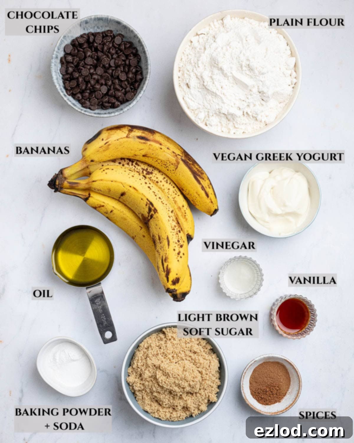 A labelled photo of all the fresh and pantry ingredients needed to make delicious vegan banana muffins.