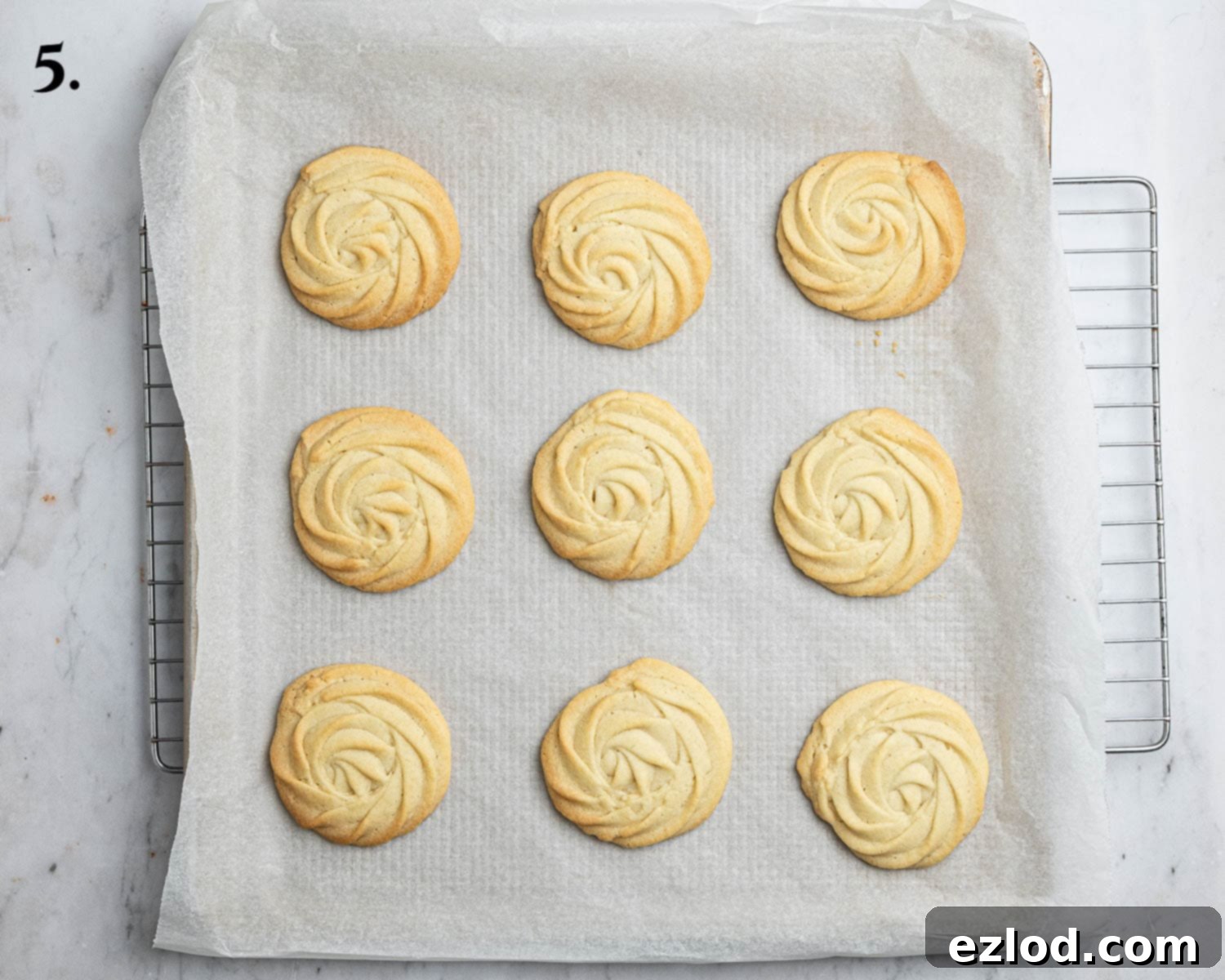 Dairy-Free Viennese Delights 9 Step 5 in making vegan Viennese whirls: The freshly baked biscuits, golden and delicate, cooling on a tray.