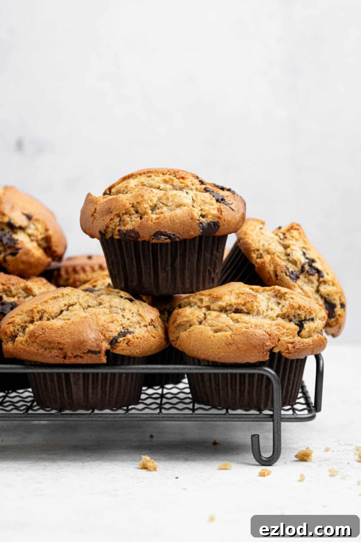 A stack of vegan peanut butter muffins on a wire cooling rack.