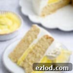 A slice of vegan lemon layer cake on a white plate.