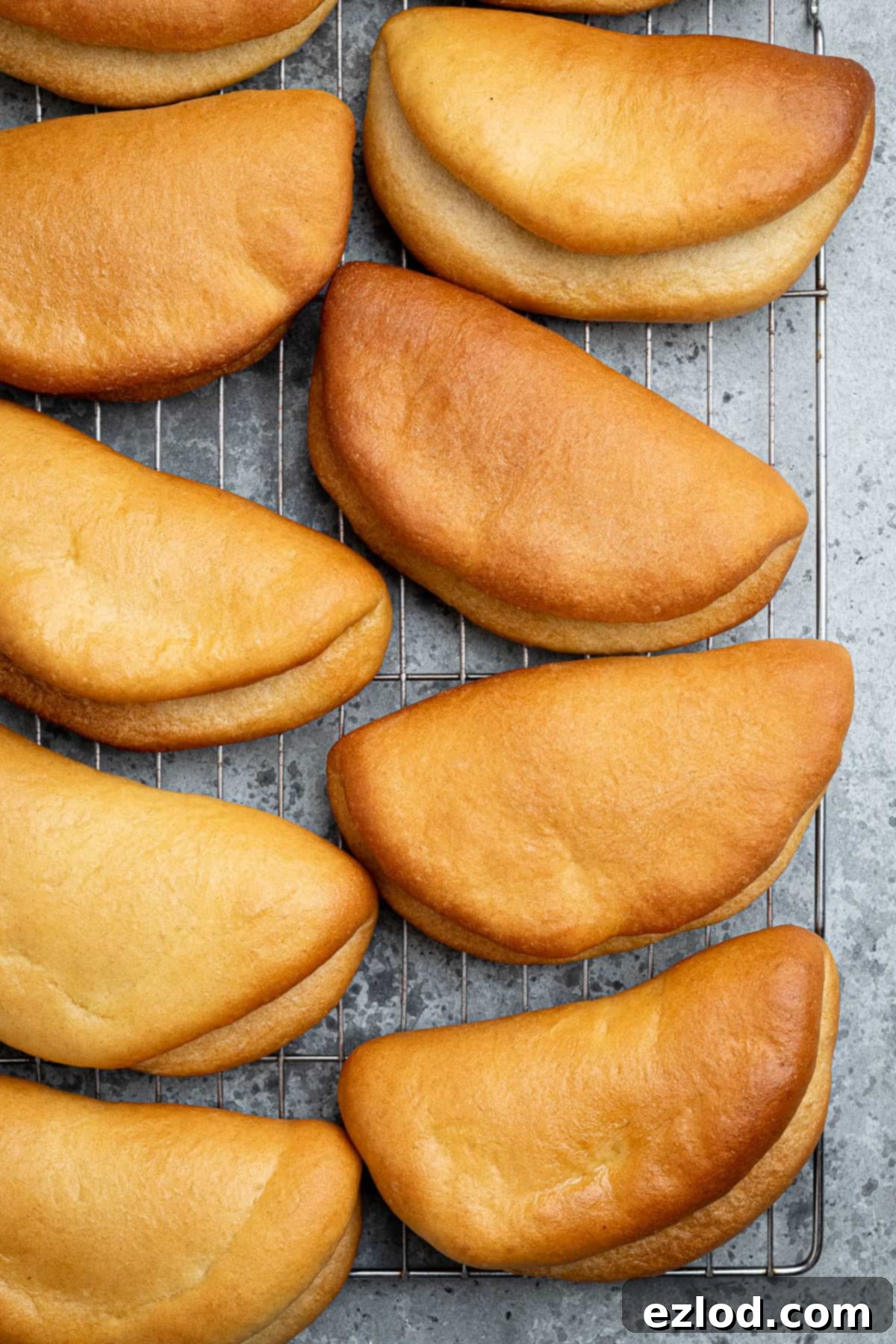 Vegan coco bread on a wire cooling rack.