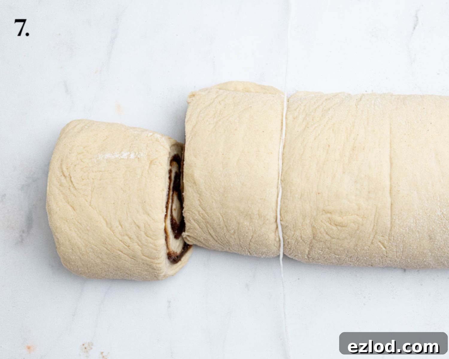 Step 7, the rolled up log of dough being cut with dental floss.