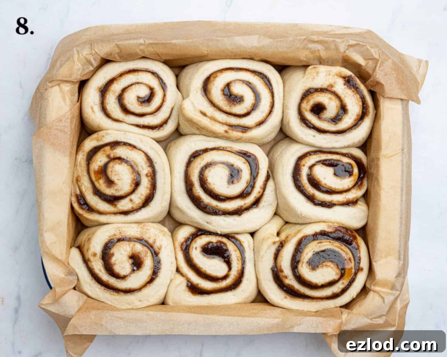 Step 8, the risen rolls in the tin.
