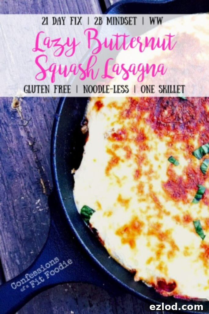 Close up overhead view of cast iron skillet filled with butternut squash lasagna. The top cheese layer has been broiled to a golden brown and garnished with basil. It has text overlay- 21 Day Fix | 2B Mindset | WW | Lazy Butternut Squash Lasagna | Gluten Free | Noodle-less | One Skillet | Confessions of a Fit Foodie. 