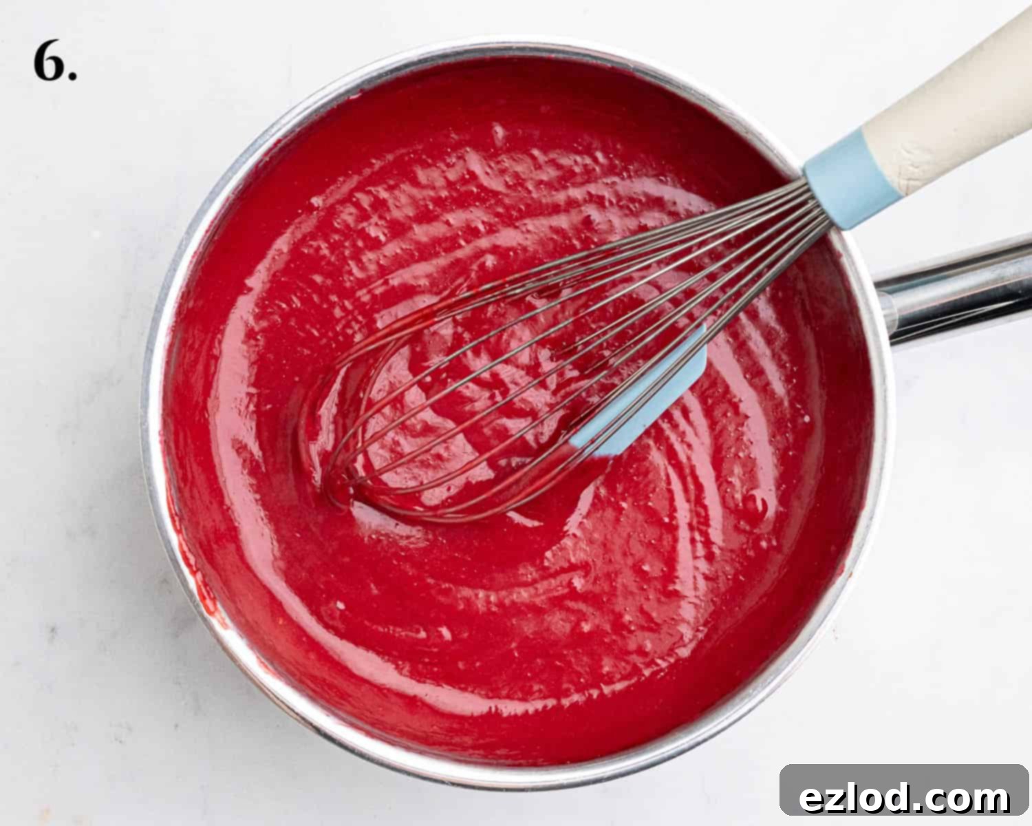 Step 6 in making vegan raspberry curd: The finished, smooth, and vibrant curd settling in a bowl, ready for chilling.