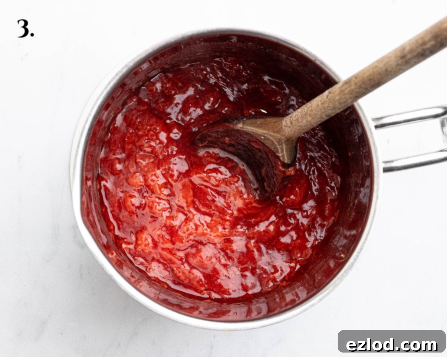 Step 3 in making vegan strawberry cheesecake ice cream: the strawberry sauce, now thickened with cornflour, cooling in a bowl.