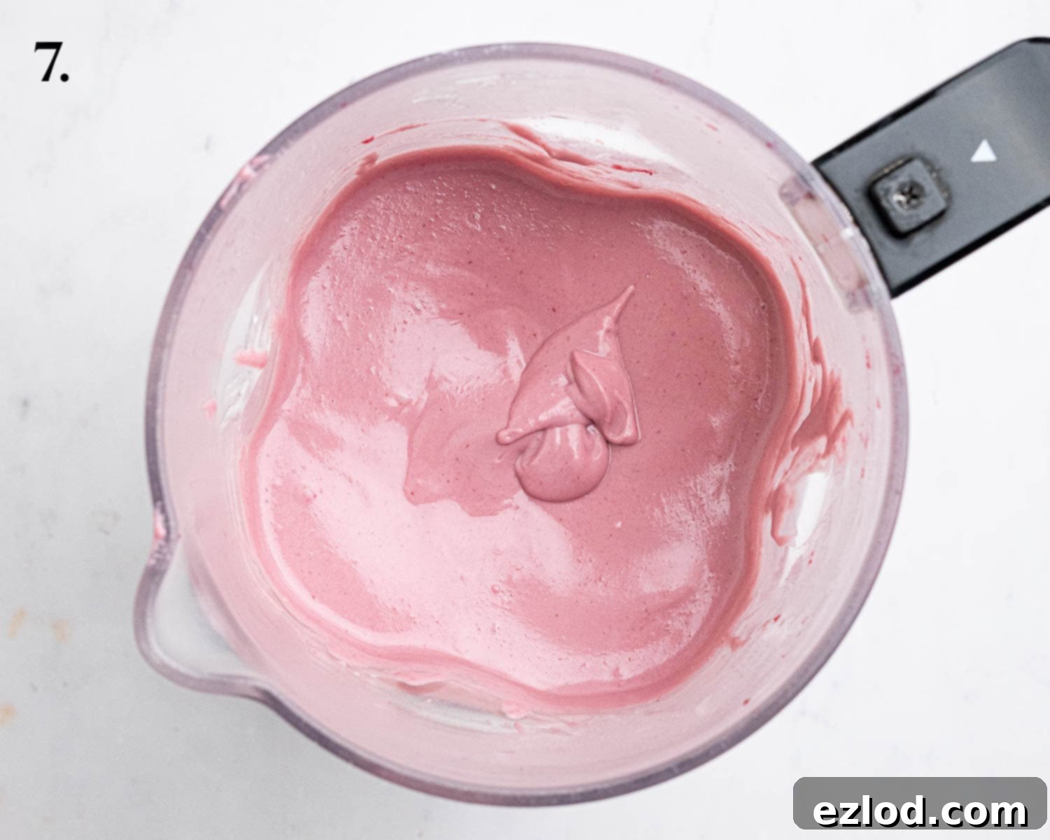 Step 7, the fully blended, smooth and creamy cheesecake filling in a blender, ready to be poured.