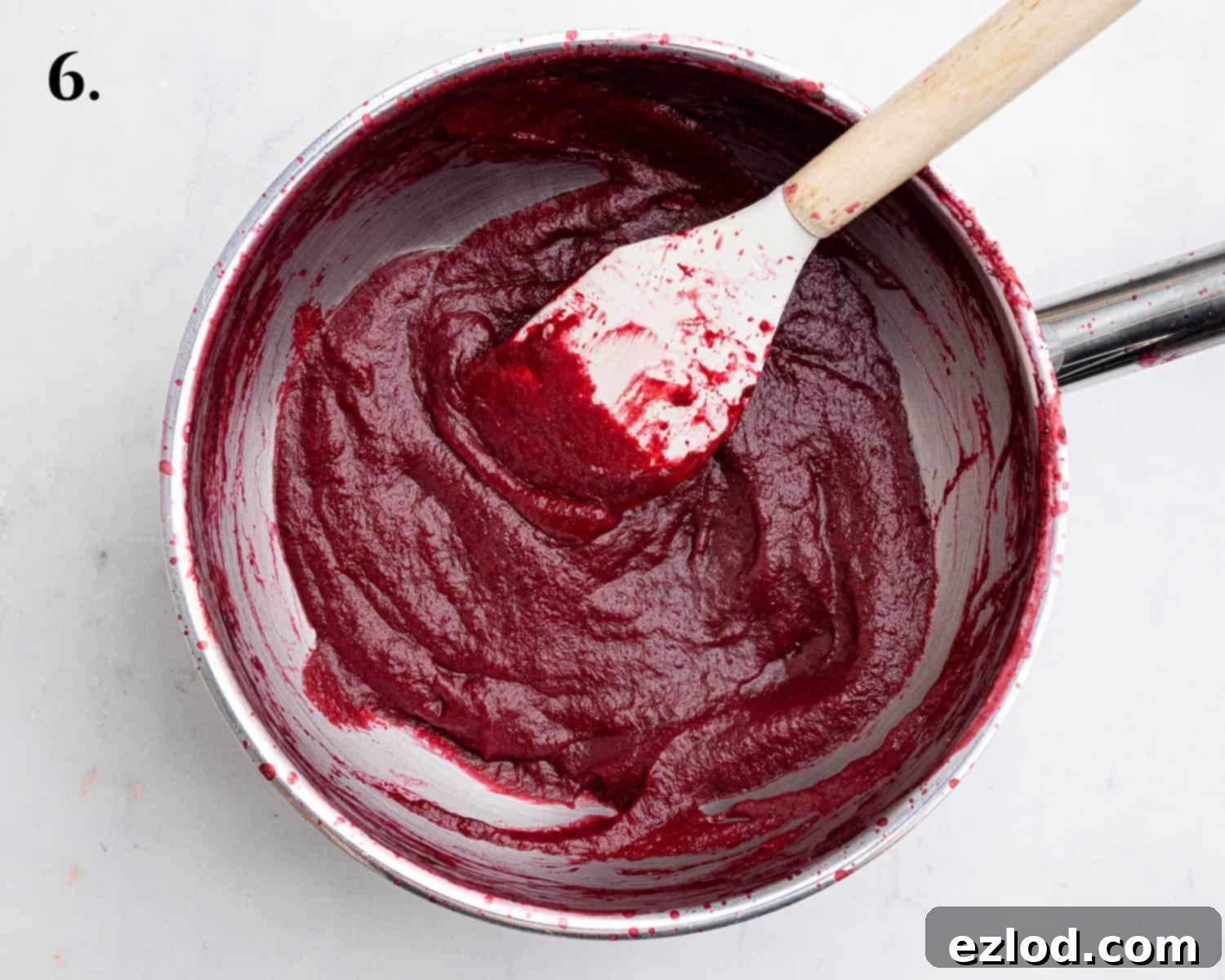 Step 6, the raspberry puree after being reduced on the stovetop, now a thick, concentrated paste.