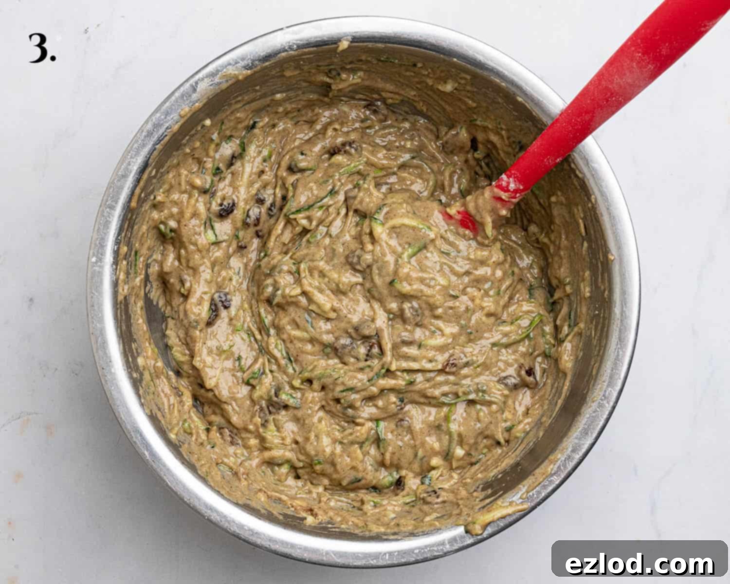 Vegan Zucchini Spice Cake 7 Step 3: The complete spiced courgette cake batter, smooth and thick, with sultanas folded in, ready for transfer to the baking tin.