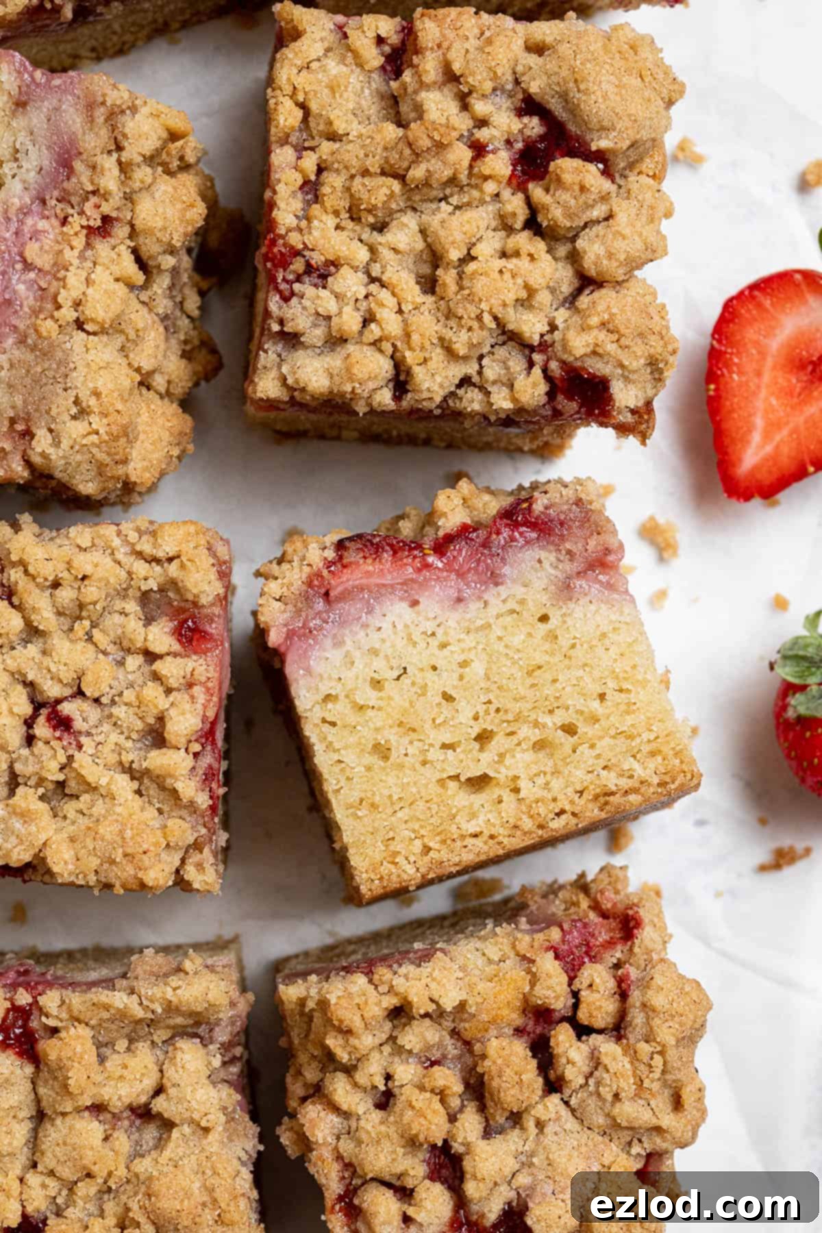 Vegan Strawberry Crumb Cake 14 Close up of a single square of vegan strawberry crumb cake, highlighting the texture and layers.