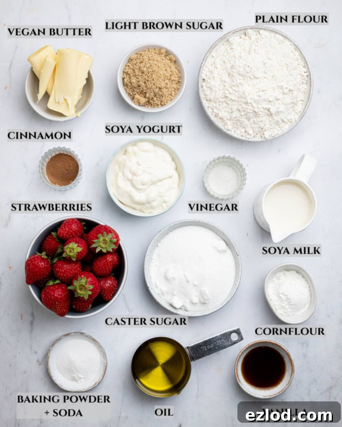 Vegan Strawberry Crumb Cake 3 A labelled photo of the ingredients needed to make vegan strawberry crumb cake, laid out on a kitchen counter.