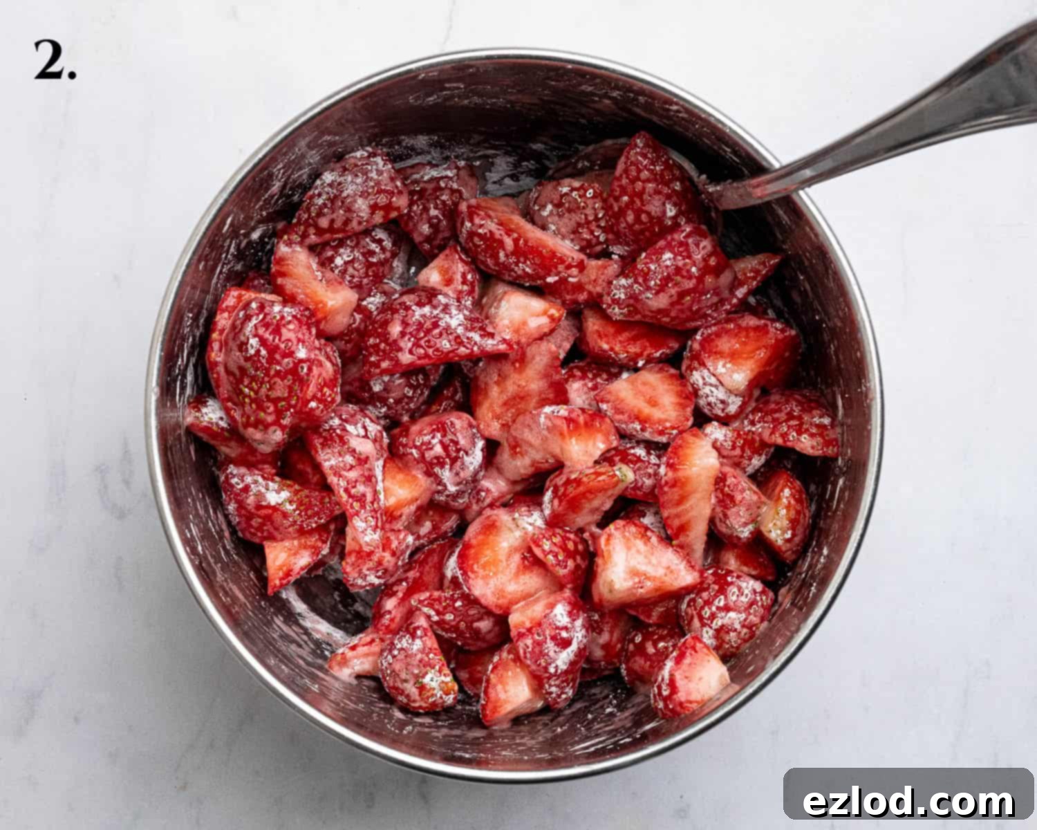 Vegan Strawberry Crumb Cake 6 Step 2: Sliced fresh strawberries mixed with sugar and cornflour in a bowl.