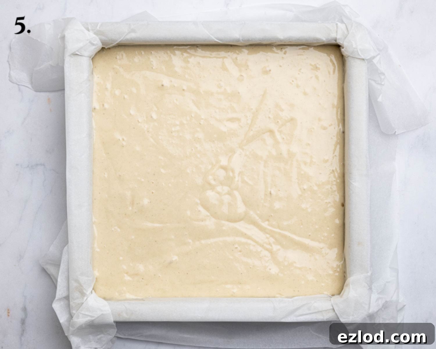 Vegan Strawberry Crumb Cake 9 Step 5: The cake batter poured into a lined square baking tin.