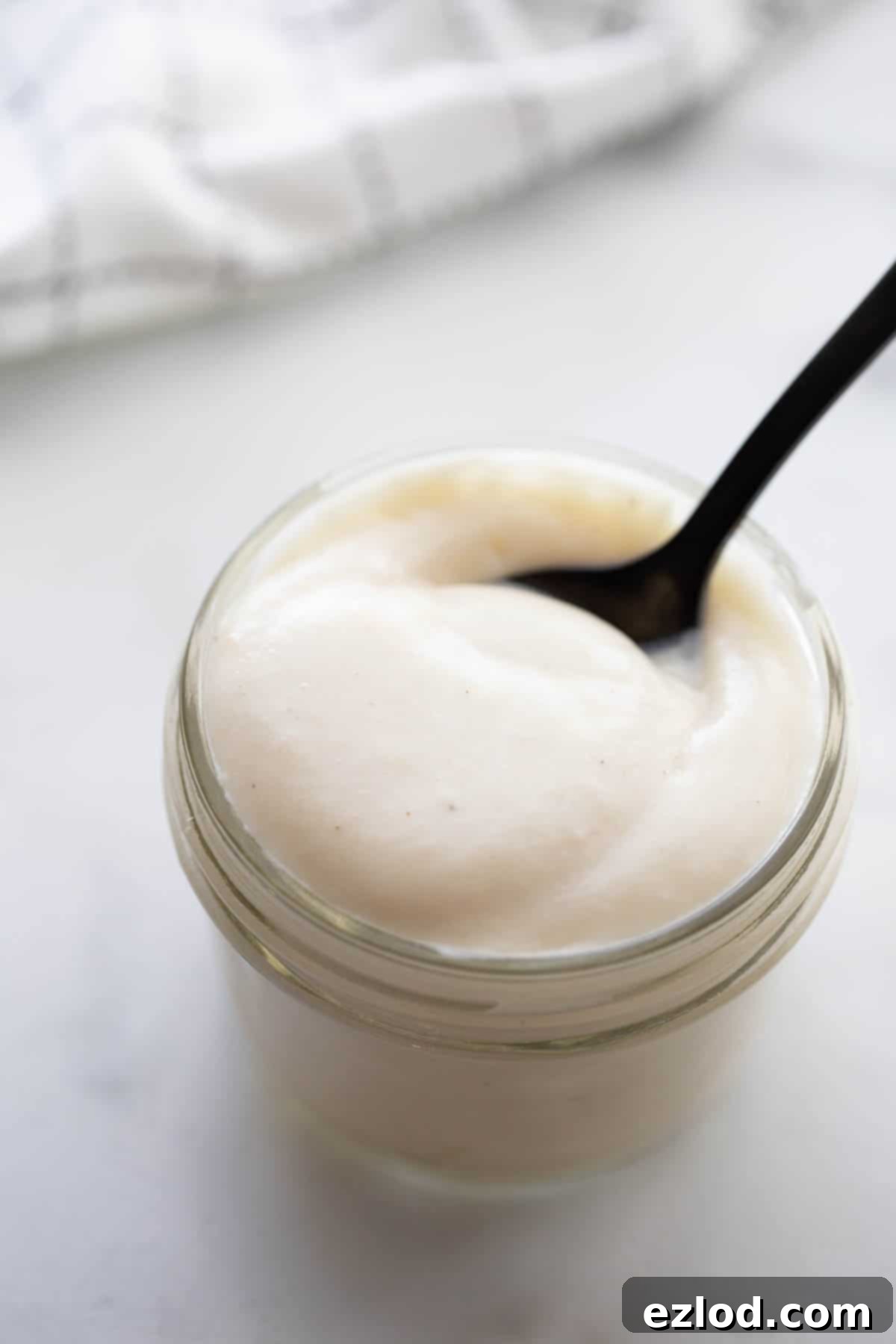 A small mason jar with a homemade cream of chicken soup substitute