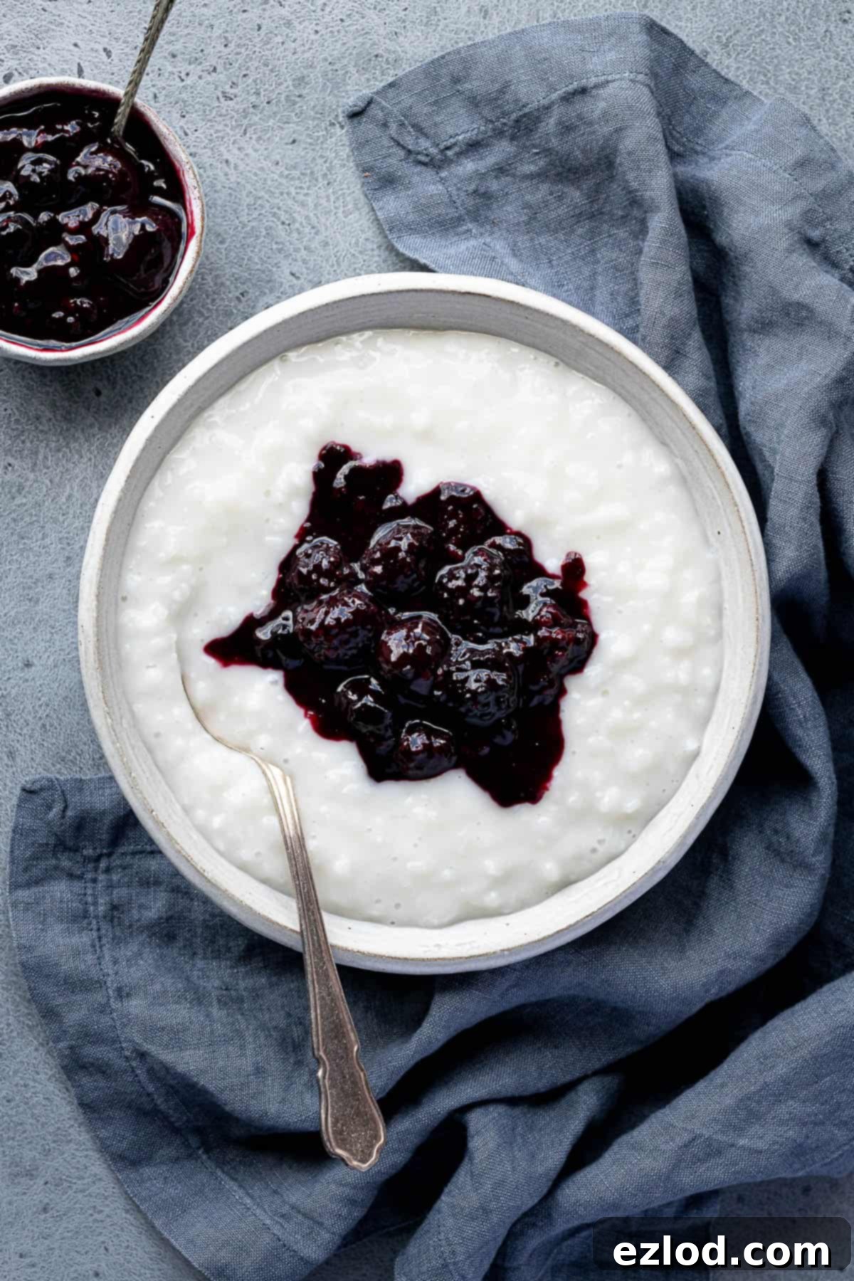A bowl of coconut rice pudding topped with berry compote.