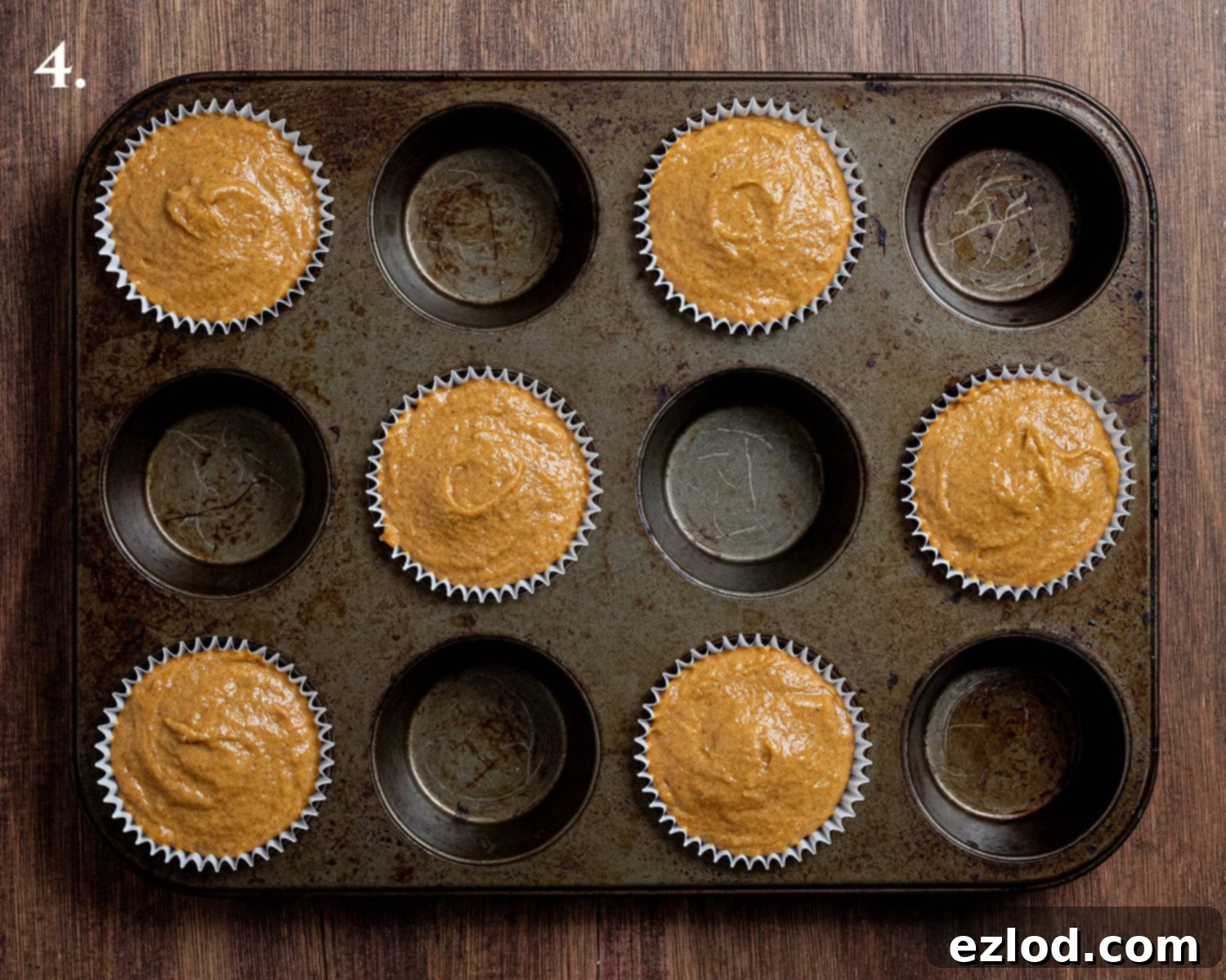 Step 4: Muffin batter neatly scooped into paper cases, almost to the top.