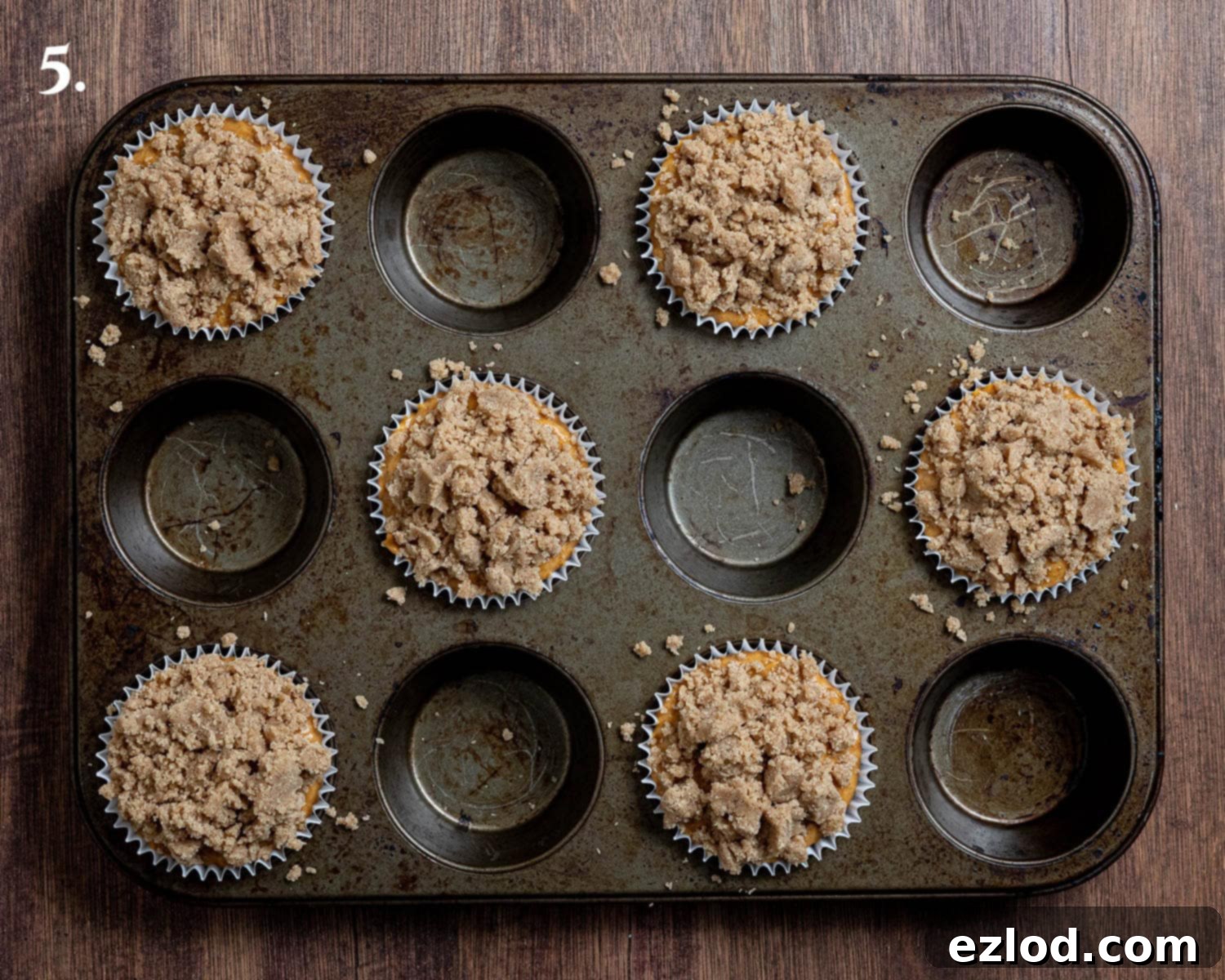 Step 5: Unbaked muffins generously topped with streusel, ready for the oven.
