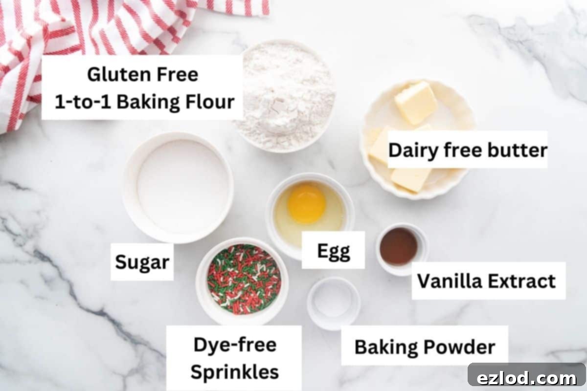 A beautifully arranged photo of labeled ingredients for Gluten and Dairy Free Sugar Cookies, including dairy-free butter, sugar, egg, vanilla extract, and gluten-free flour.
