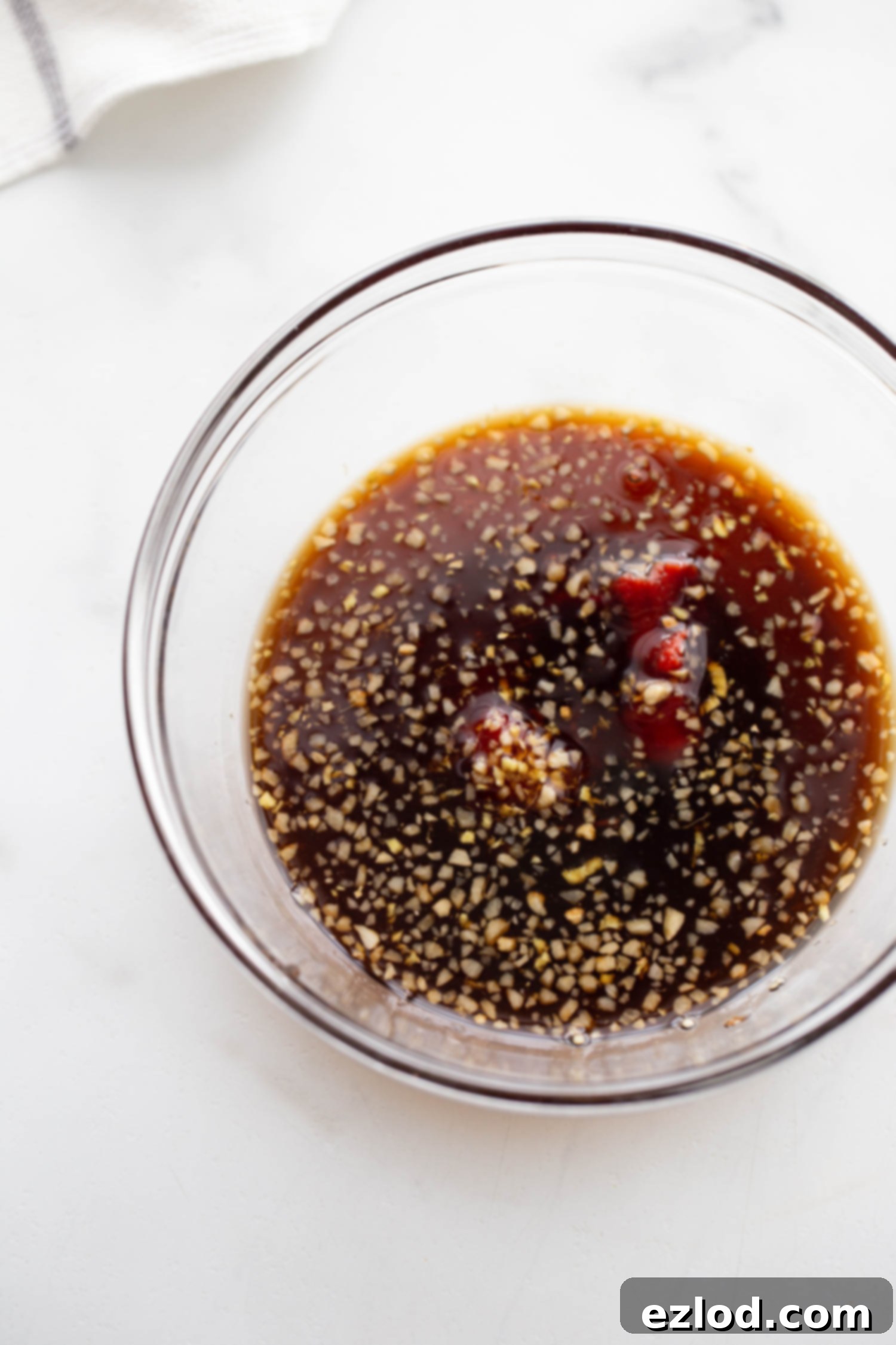 Homemade stir fry sauce with tomato paste, maple syrup, coconut aminos, garlic and ginger.